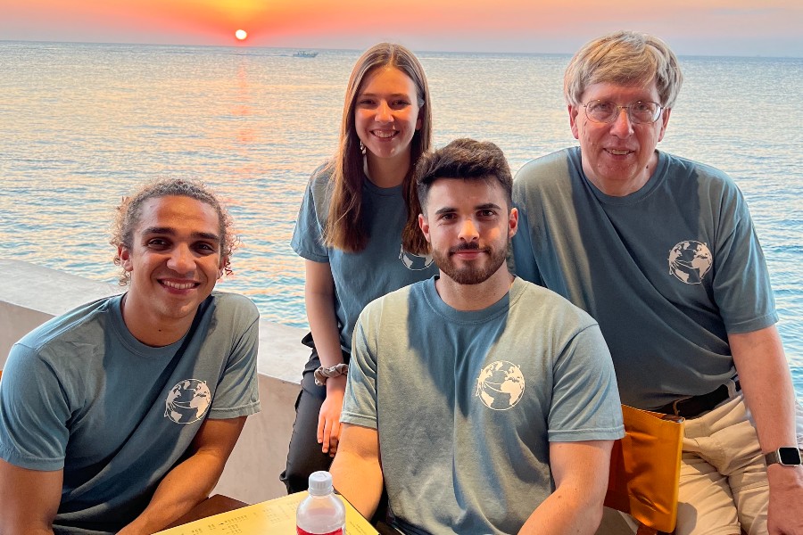 Three students with professor Perry Moore in Cozumel