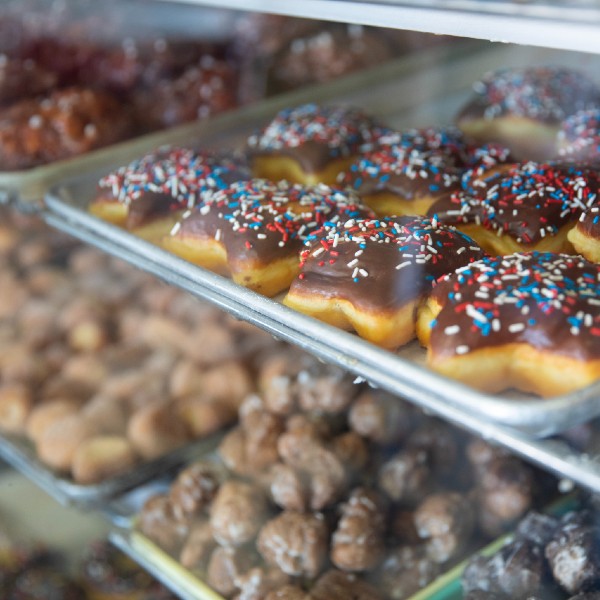 Photo of star-shaped donuts and donut holes in the display case.
