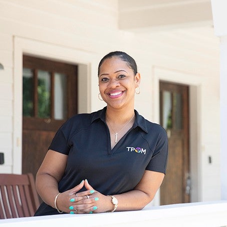 Reisha Kidd pictured on the porch of a transitional house