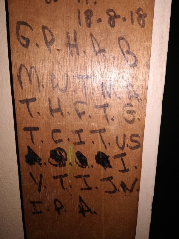 Letters written on a wooden doorframe