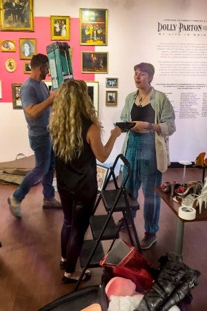 Brynn Abner working with the exhibit in the gallery