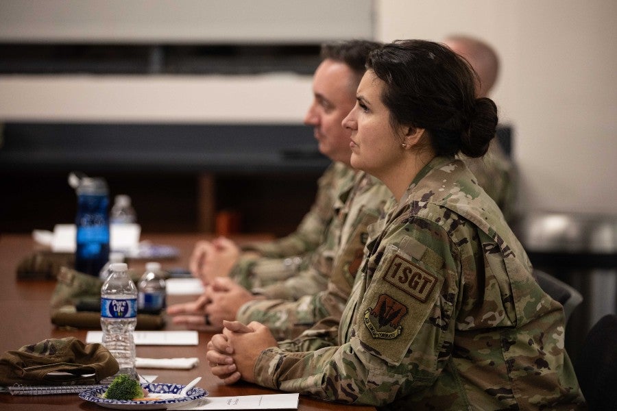 Female guardsman in the forefront of picture of soldier-students in the classroom