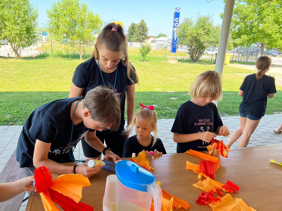 local teens help kids with a craft at Croatian kids' camp