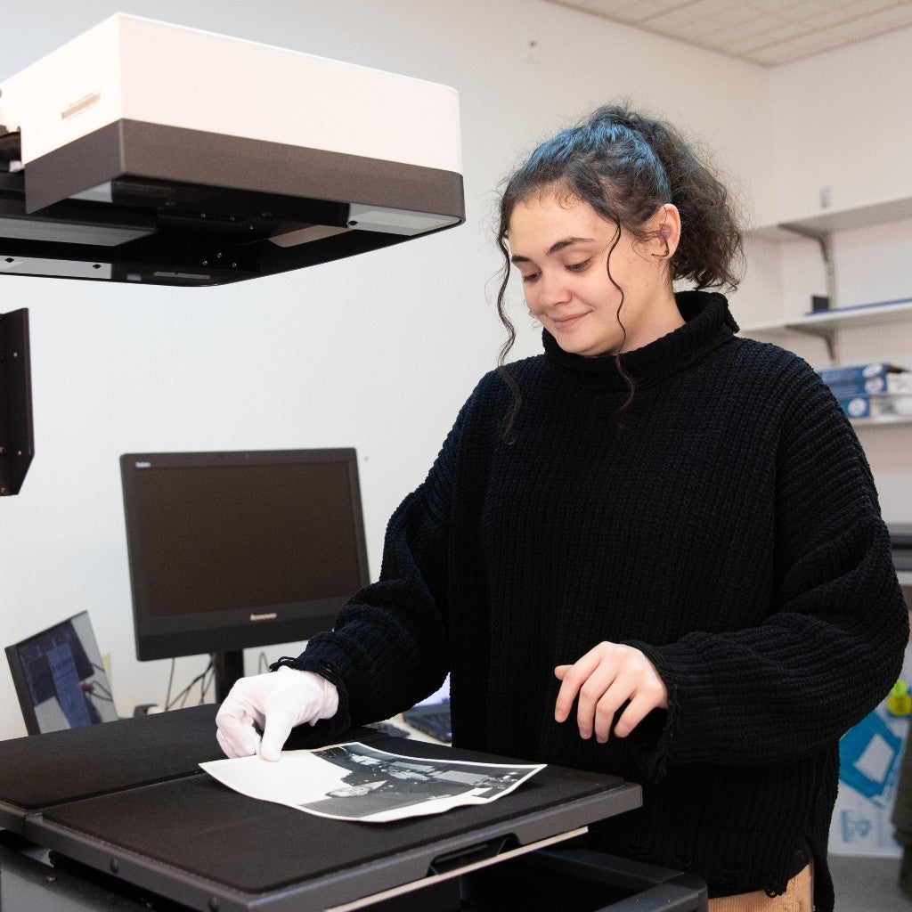 Paiton Walker working with archive photos