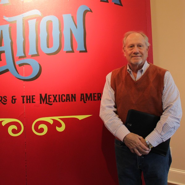 Tim Johnson standing in front of Shaping a Nation display