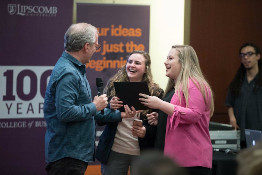 students with gentleman holding microphone