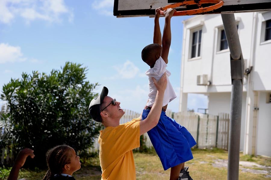 There are many opportunities for you to serve your community and world. Here, one of our students on mission in Saba gives a lift to a young friend during a game of basketball.