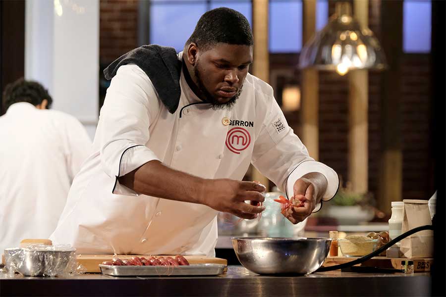 Gerron Hurt removing crawfish from ice during the MasterChef season 9 finale.