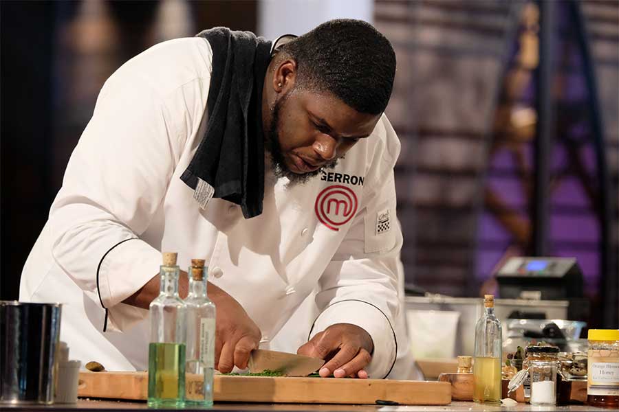 Gerron Hurt chopping herbs during the MasterChef season 9 finale.