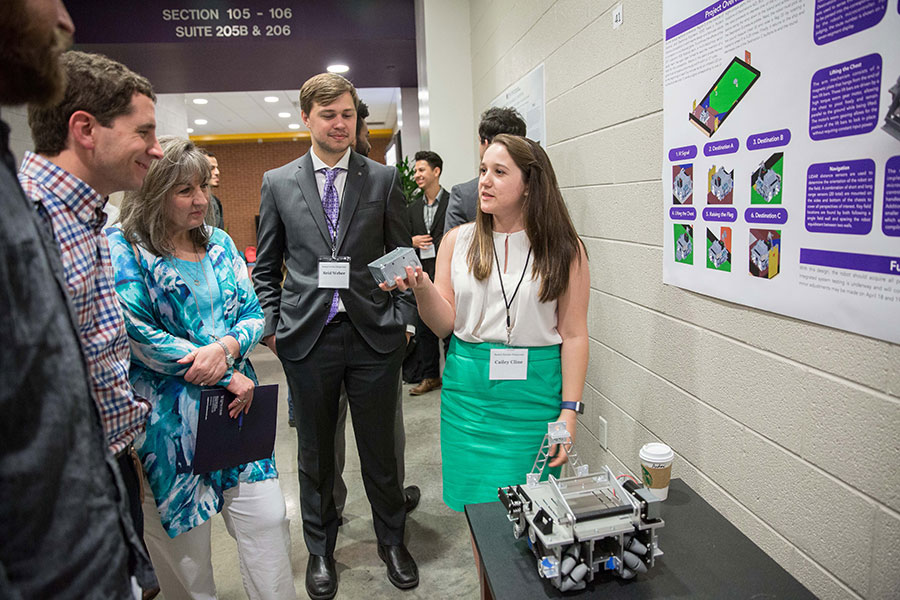 A student explains her findings during the Students Scholars Symposium.