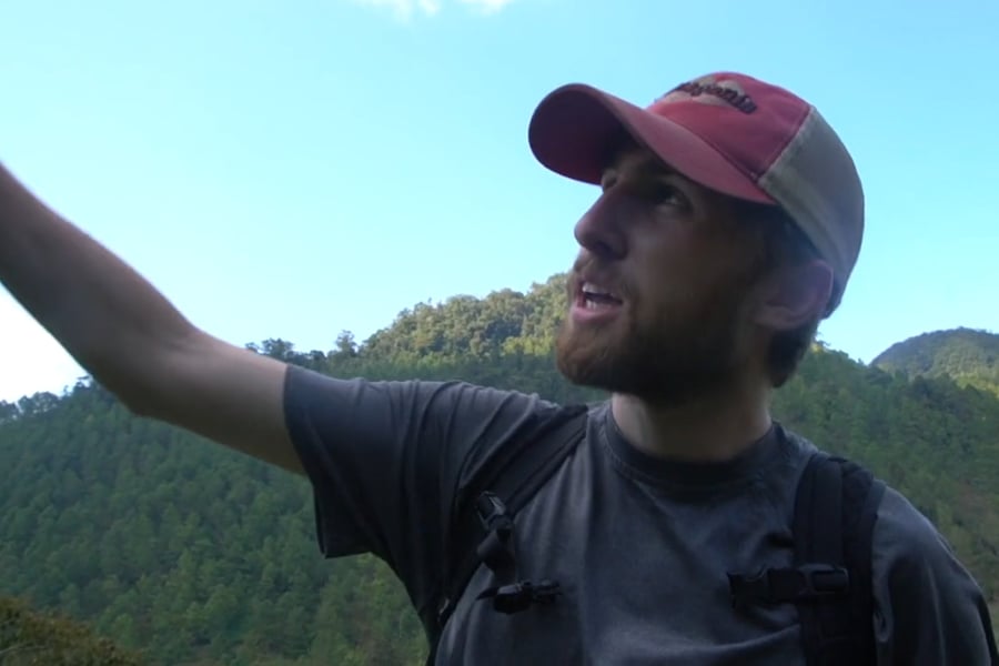 A male student points to a location off camera