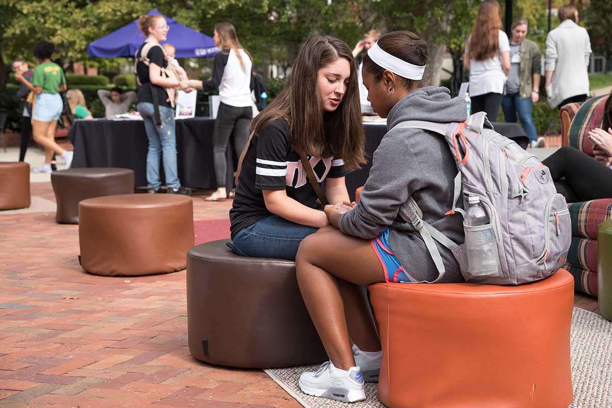 Students pray together in the Bison Square. 