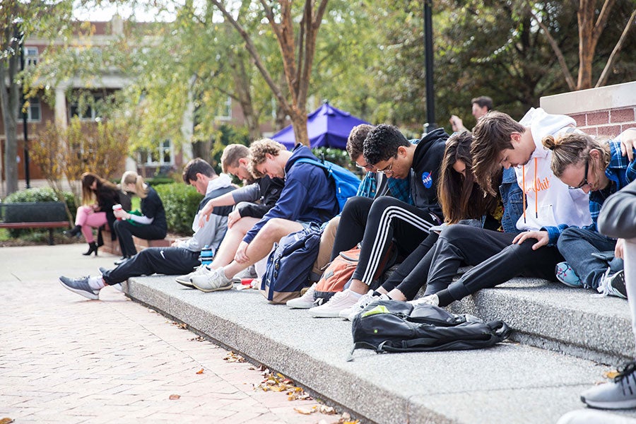 Students take part in a prayer vigil in Bison Square.