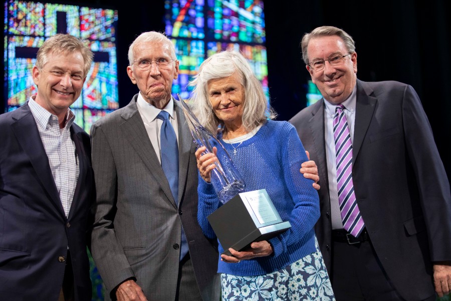 Group of four individuals holding Kopio Award