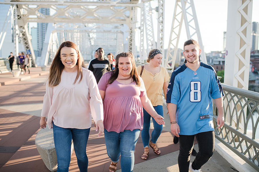 More than four students walking on the pedestrian bridge in downtown Nashville.