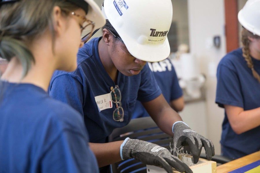 Michaela Kirk helping girls at Girls Build It camp