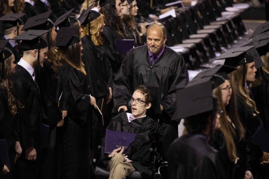 Seth and Ken headed back to their seat at the May 2019 graduation.