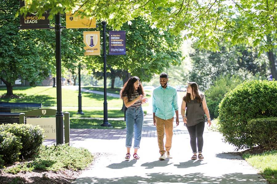 Three people walking on campus