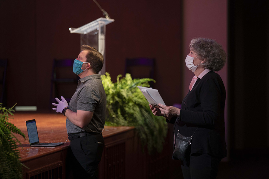 Lipscomb officials in masks overseeing the filming of the commencement ceremony.