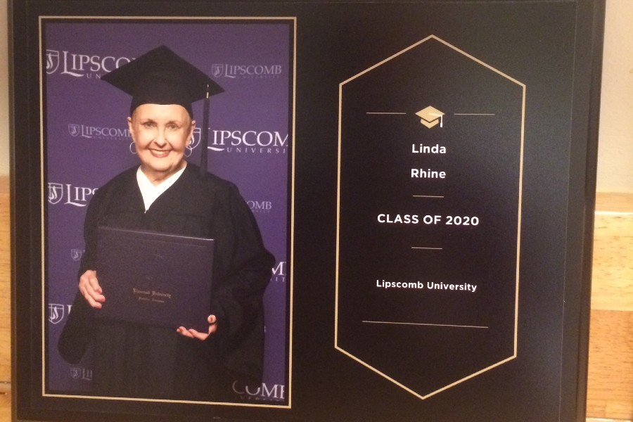 Linda Rhine in cap and gown photo in a graduation frame
