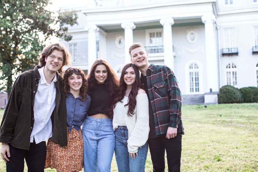 The five hosts and Hostesses posing in front of Longview Mansion