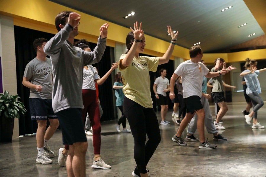 Students rehearsing a dance in the Allen Arena lobby