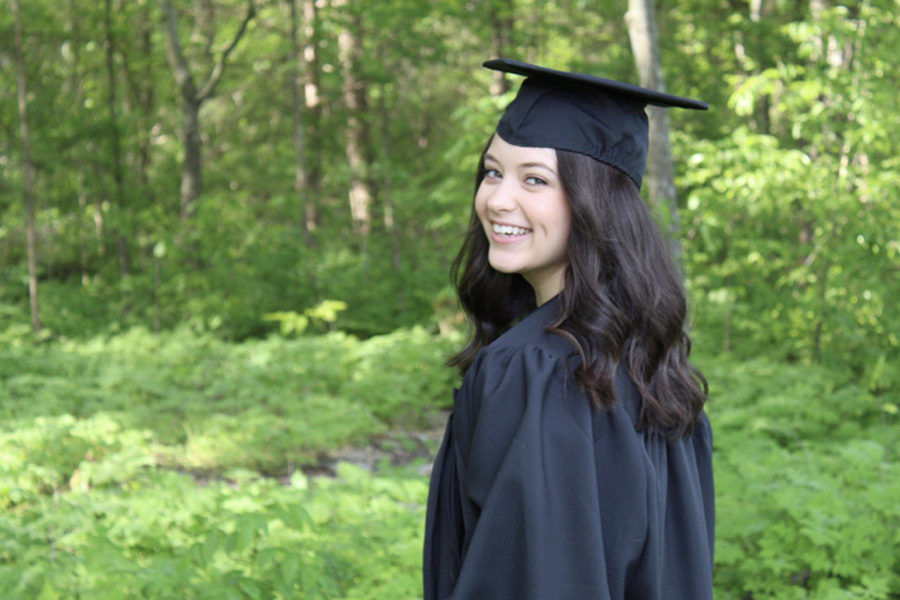 Olivia Malham posing in cap and gown