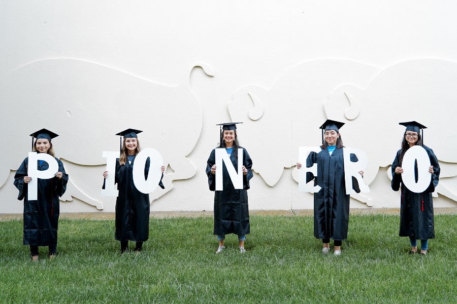 The Pionero students holding up letters spelling PIONERO