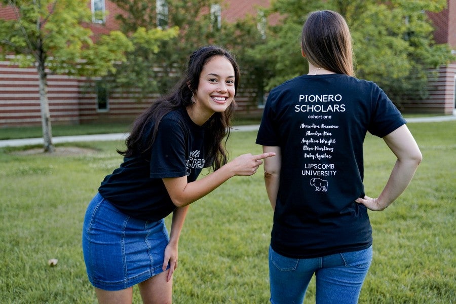 Anjelica Wright pointing to a Pionero T-shirt