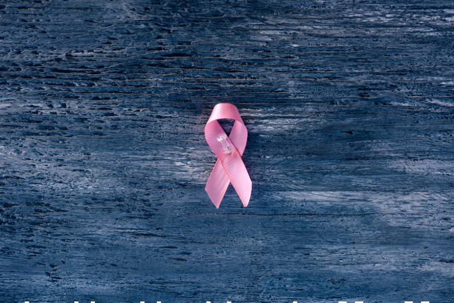 Picture of pink ribbon on wooden board