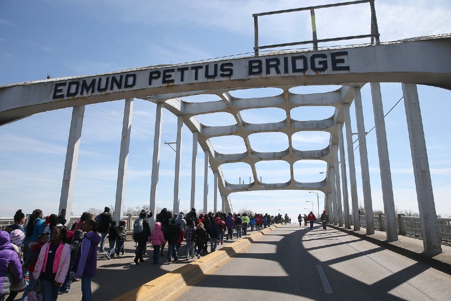 Group of visitors crossing the Edmund Pettus Bridge