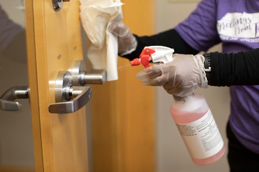 Facilities worker cleaning surfaces