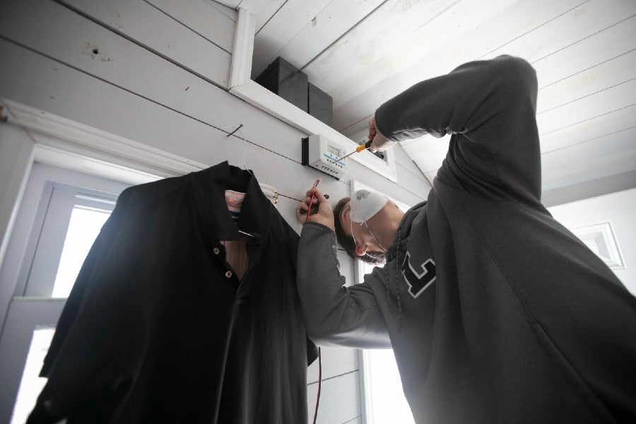 Engineering student installing electrical equipment