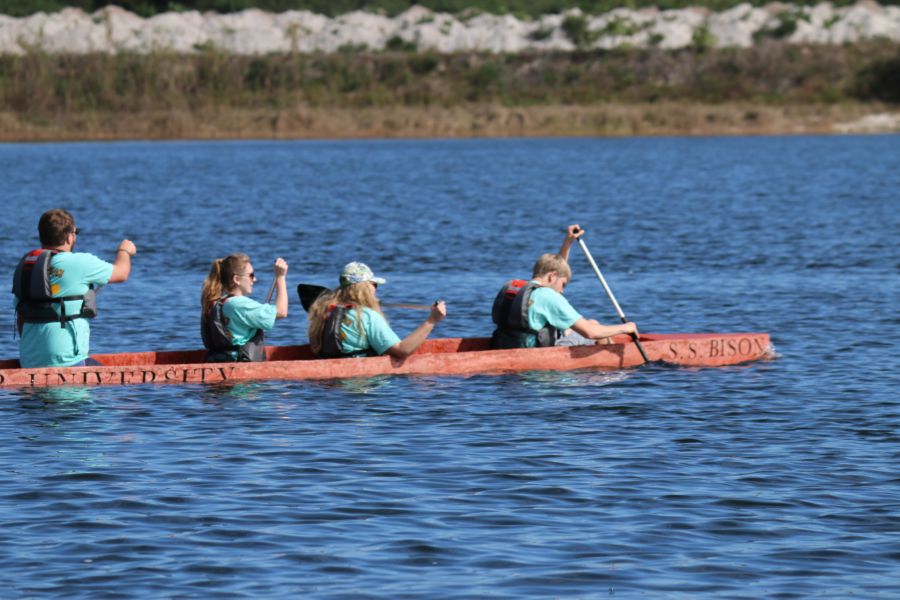 Students on the water using the canoe