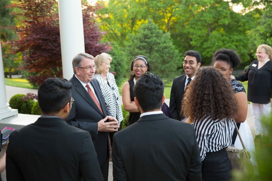 Lowry speaking with a group of students