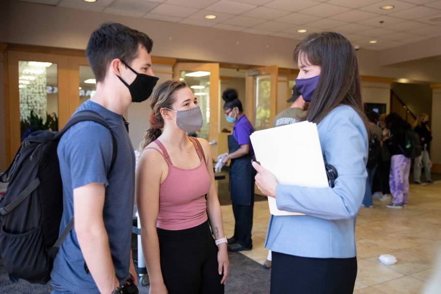 Dr. McQueen meets student in the campus center