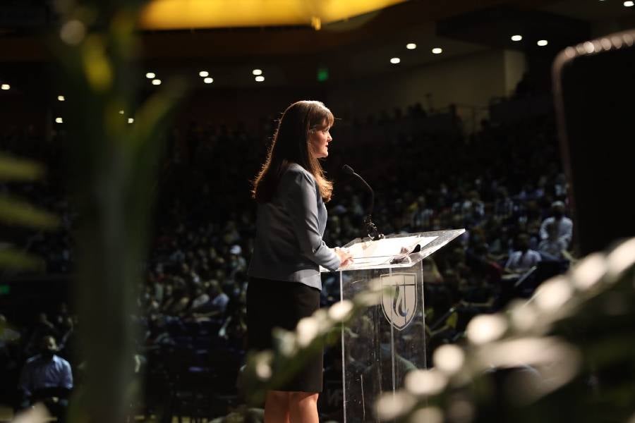 McQueen speaks in the Gathering to students.