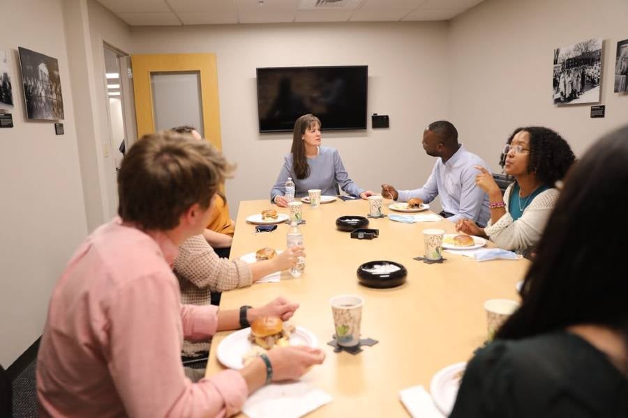 Dr. McQueen eats lunch with representatives of student organizations.