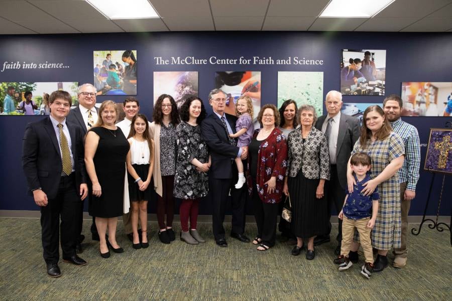 McClure family in front of center sign