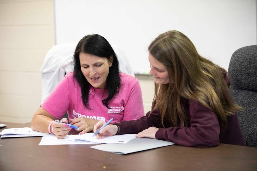 Student works with business accelerator participant. 