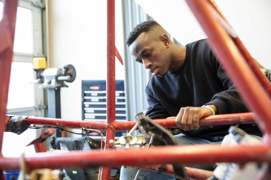 Students working on senior project, an ATV