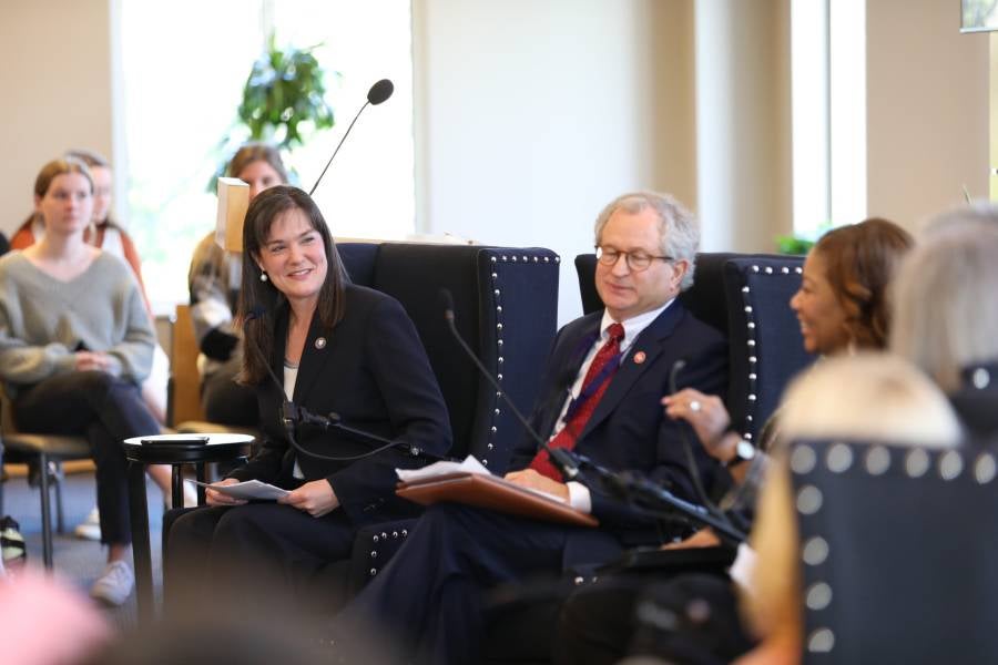 Dr. McQueen with education panelists Mark White and Adrienne Battle.