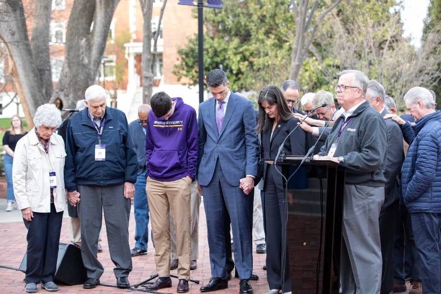 McQueen family being prayed over during devotional service. 