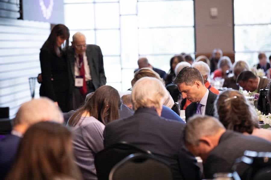 Carl McKelvey prays over Dr. McQueen