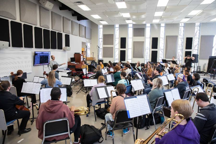 Students in the wind ensemble and chamber strings record music