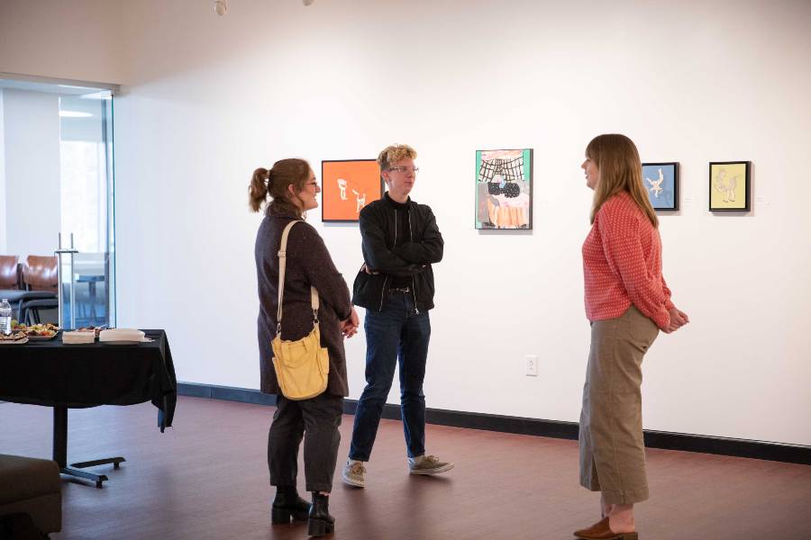 Artist talking about paintings in exhibit