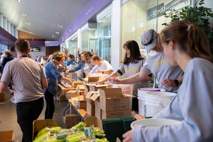 students filling buckets for Ukraine