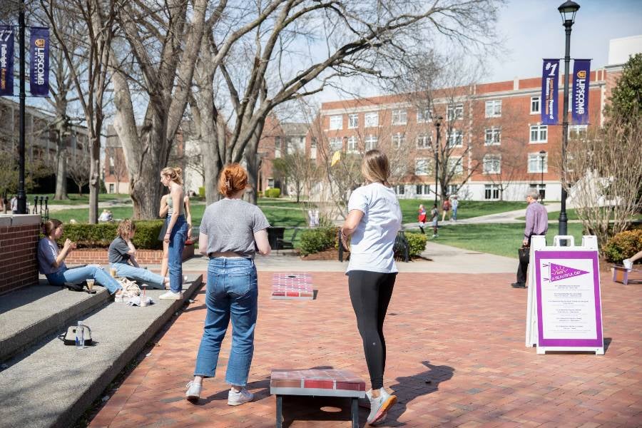 students enjoying campus on beautiful day. 