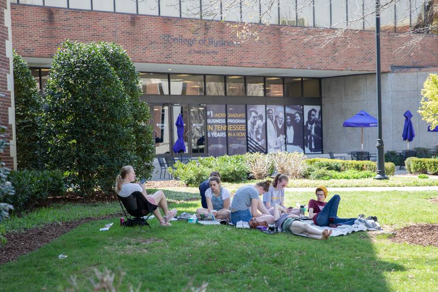 students enjoying campus on beautiful day. 