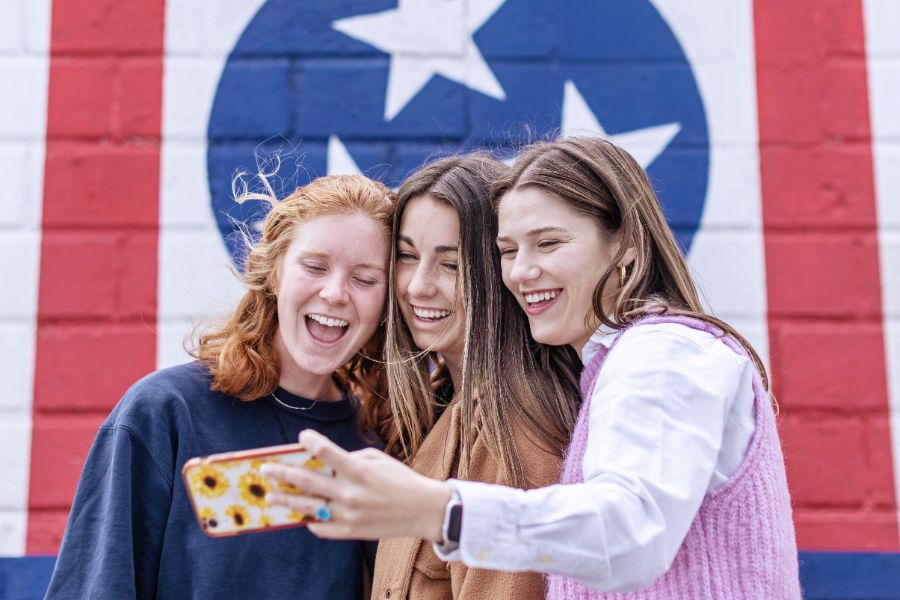 Girls taking a selfie in front of a mural in the 12 South neighborhood
